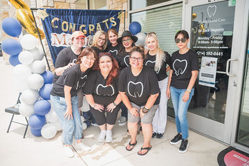 Multiple people gathered in front of dental office