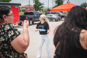 Woman carrying blue plate through parking lot