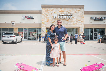 Family in parking lot in front of dental office