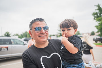 Close-up of man carrying his son