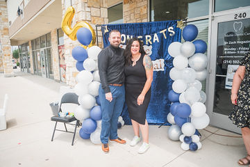 Far shot of man and woman standing in front of banner