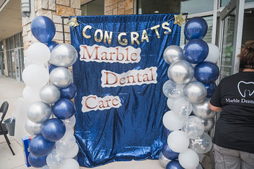 Balloons and banner that reads Congrats Marble Dental McKinney