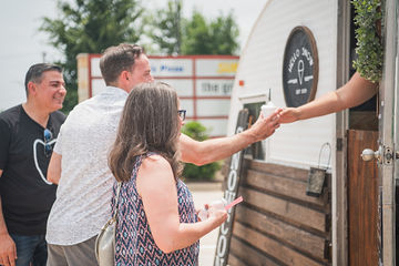 Man taking a snow cone from a food truck