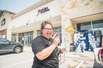 Woman laughing and walking through parking lot