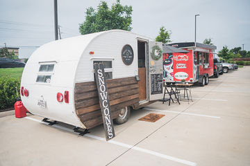 Angled shot of trailer with sign that says snow cone