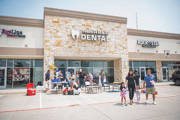 Shot of Marble Dental McKinney with celebration happening in front