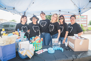 Dental team members wearing shirts with tooth symbols on them