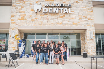 Dental team having picture taken outside of Marble Dental McKinney