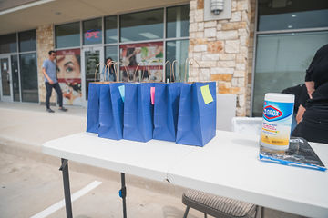 Blue paper bags sitting on a table outdoors
