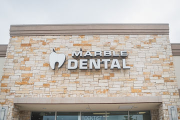 Close-up of the words Marble Dental McKinney on front of dental practice