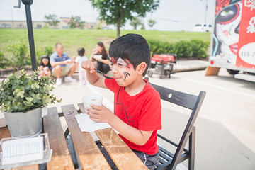 Little boy with red shirt and tiger facepaint