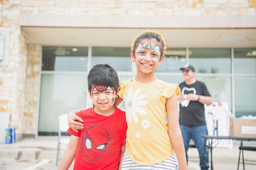 Two kids with face paint smiling together