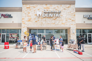 Multiple people participating in celebration outside of Marble Dental McKinney