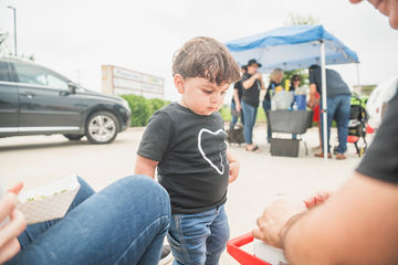 Close-up of little boy in parking lot