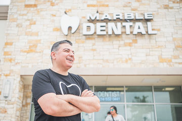 Man smiling with arms folded in front of Marble Dental McKinney