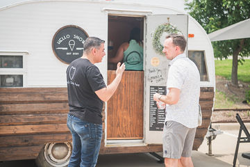 Two men standing outside of trailer with door open