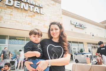Close up of woman holding little boy while wearing matching shirts