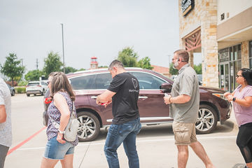 People walking in line parking lot