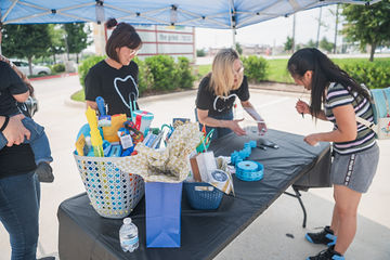 Women gathered around table working on project