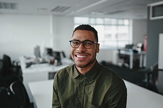 smiling person sitting in an office