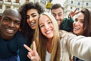 Group of friends smiling after visiting their Cigna dentist in McKinney