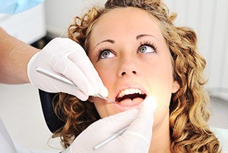 Woman receiving dental exam before getting Clear Correct in McKinney