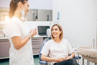 Woman speaking with a cosmetic dentist in McKinney