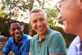 mature man happily talking to friends