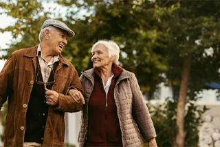 senior couple walking in park