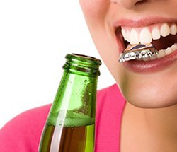Woman with bottlecap between her teeth headed for broken tooth