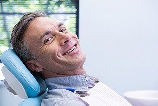 Man smiles after emergency dentistry treatment