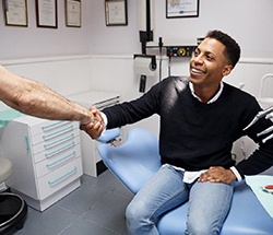 Young man shaking the hand of his dentist