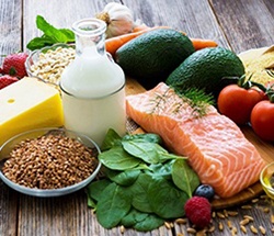 Table spread of healthy foods like salmon and avocado