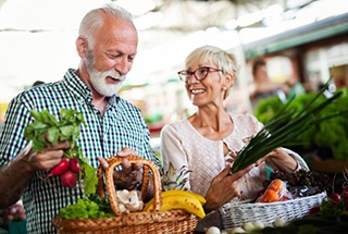 elderly couple buying fresh produce