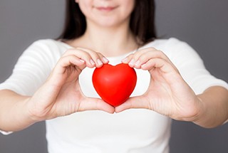 woman holding a red love heart