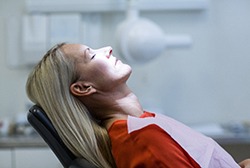 Woman with blonde hair relaxing in the dental chair