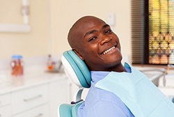 Candidate for dental implants in McKinney smiling in dental chair 