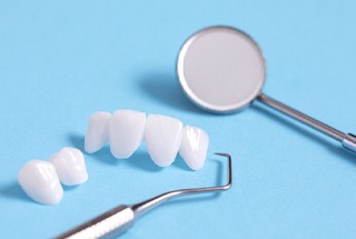 Lumineers and dental tools lying on table