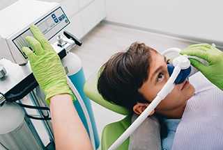 dentist administering nitrous oxide sedation dentistry in McKinney