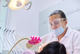 A dental professional performing a procedure on a patient who is receiving oral conscious sedation