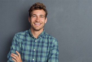 Man smiling after successful dental implant post op period