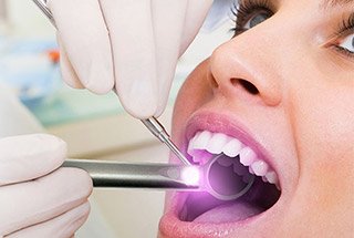 Woman receiving oral cancer screening