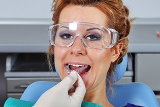 Woman being fitted for oral appliance for T M J treatment in McKinney
