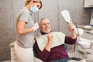 man talking to dentist about cost of veneers in McKinney