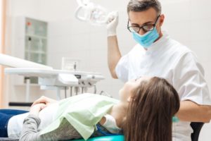 a dentist examining a female patient