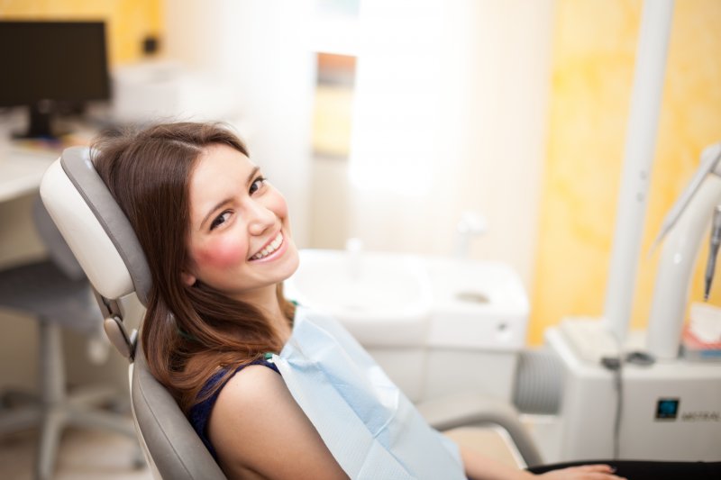 young woman sitting in dentist chair