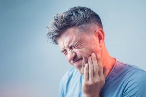 man with toothache who needs emergency dentist in McKinney