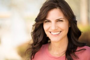 Woman smiling after visiting in-network dentist in McKinney