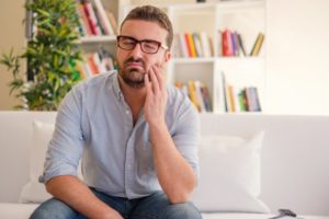 man with tooth pain who needs an emergency dentist in McKinney 