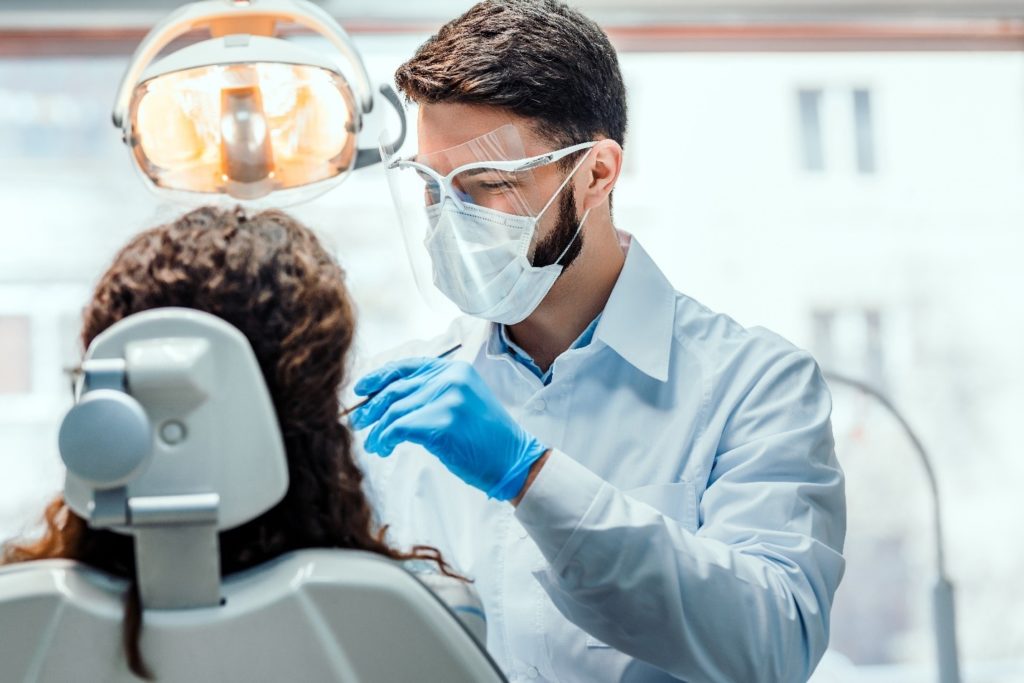 person at dentist having a dental crown placed